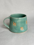Green speckled flower mug